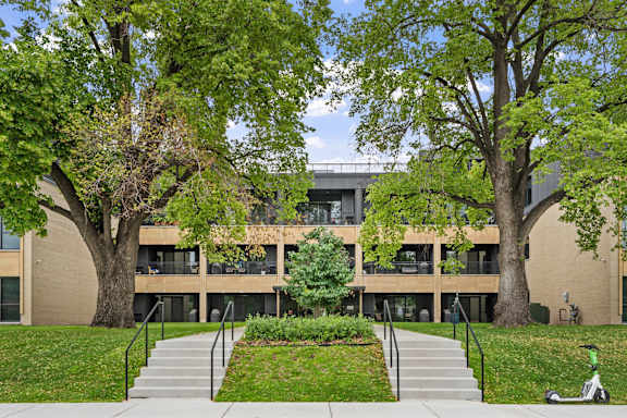 A modern building with a green lawn in front.
