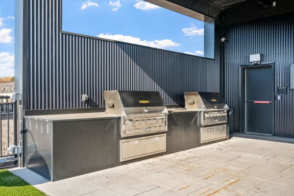 the outdoor kitchen has stainless steel appliances and a large window