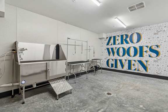 A wall with the words "Zero Woofs Given" in blue and yellow.
