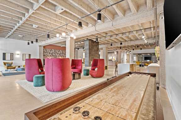 A room with a shag carpet and a long table with a shag carpet runner.