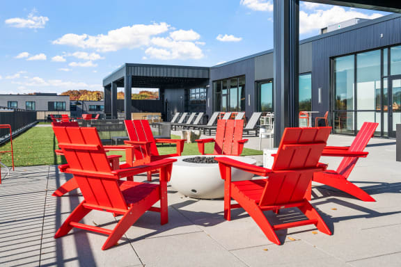 a group of red chairs outside of a building