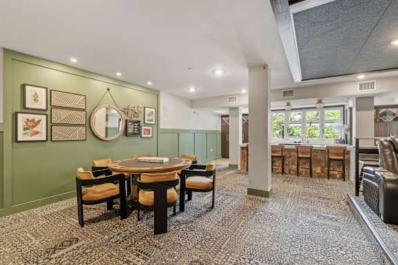 A dining room with a table set for six.