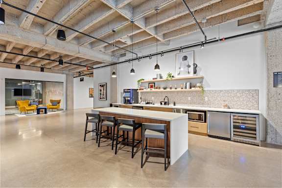 A kitchen with a bar area and a dining table.