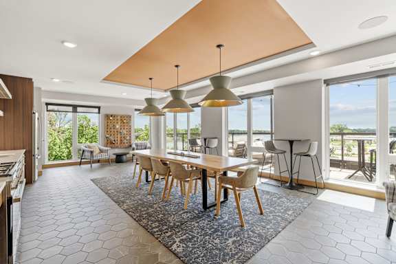 A modern dining room with a large table and chairs.
