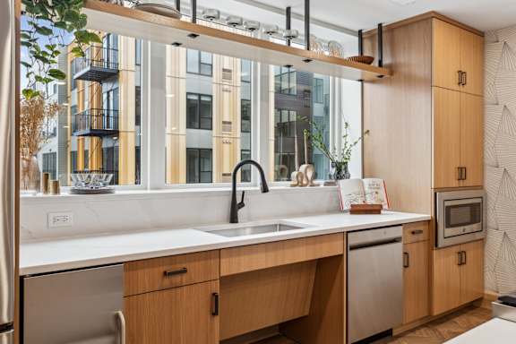 A modern kitchen with wooden cabinets and stainless steel appliances.