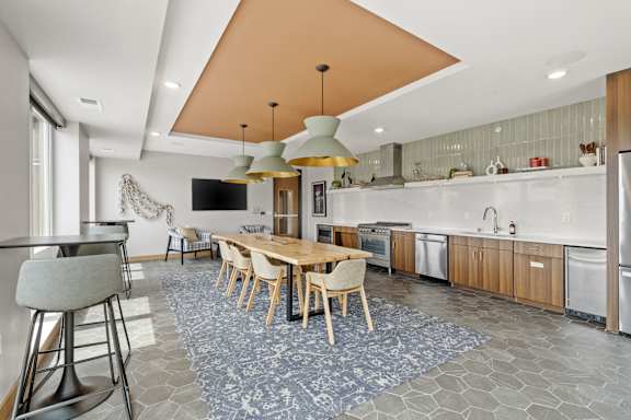 A modern kitchen with a dining table and chairs.