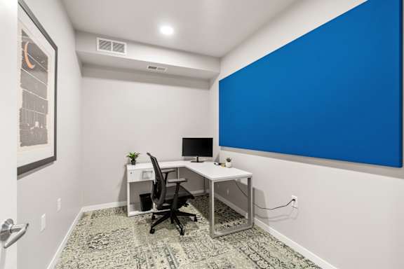 A room with a desk and a computer.