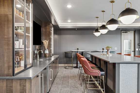 A modern kitchen with a bar area and seating.