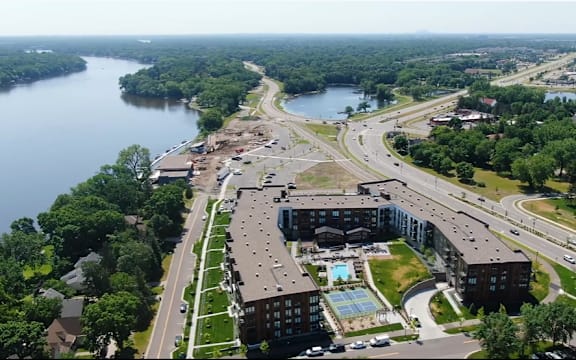 A view of a city with a river and a highway.