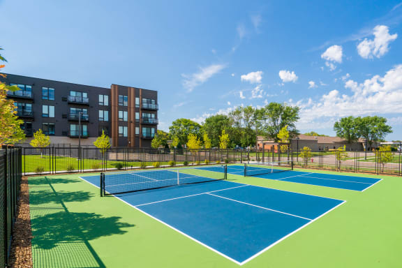 a tennis court at the flats at big tex apartments in san antonio, tx