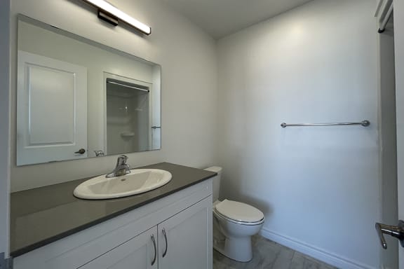 Bayfield Tower 1 bedroom 1 bathroom variation A bathroom showing vanity, mirror and toilet