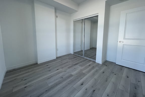 Bayfield Tower 1 bedroom 1 bathroom variation A bedroom with sliding mirror closet doors