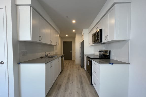 Bayfield Tower 1 bedroom 1 bathroom variation A walk-through galley kitchen looking toward entryway