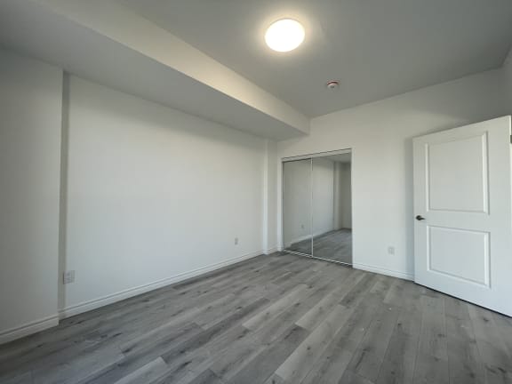 Bayfield Tower Apartments 1 bedroom 1 bathroom variation D bedroom with sliding mirror closet door