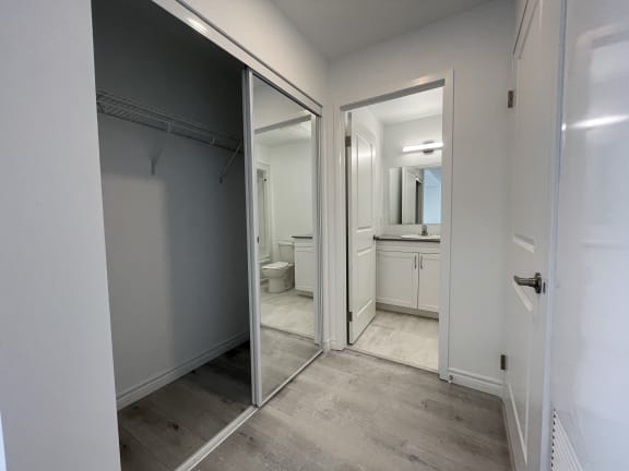Bayfield Tower Apartments 1 bedroom 1 bathroom variation D hallway with large closet with sliding mirrored doors