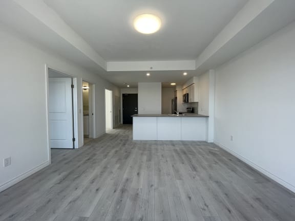 Bayfield Tower Apartments 2 bedroom 1 bathroom variation A living room with kitchen in the background