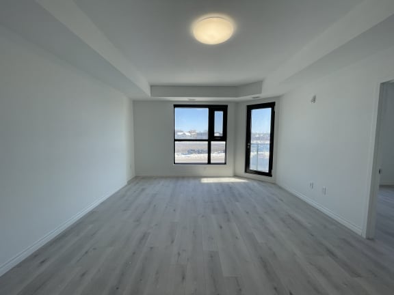 Bayfield Tower Apartments 2 bedroom 1 bathroom variation A living room with large window and glass patio door