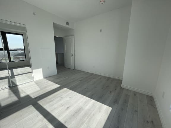 Bayfield Tower Apartments 2 bedroom 1 bathroom variation A primary bedroom with sliding mirror closet door
