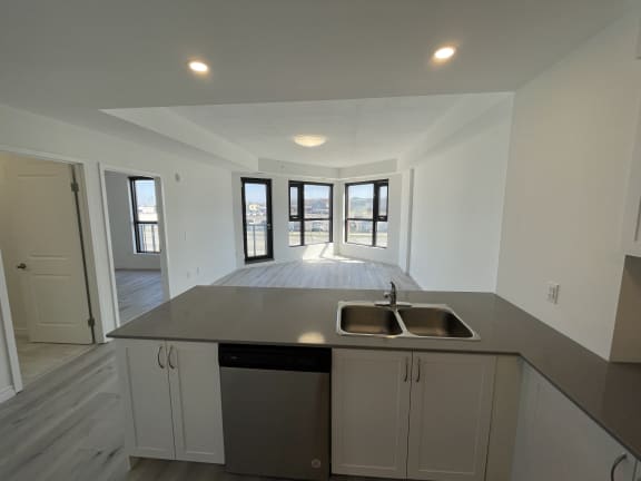 Bayfield Tower Apartments 2 bedroom 1 bathroom variation B kitchen breakfast bar with stainless steel sink and double dins