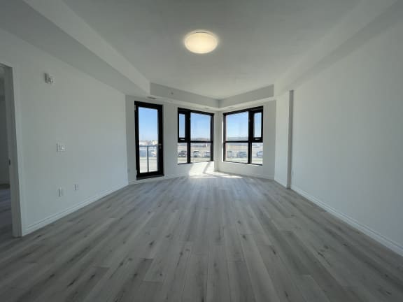 Bayfield Tower Apartments 2 bedroom 1 bathroom variation B living room with large windows and glass patio door
