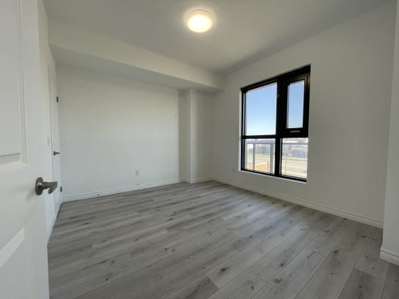 Bayfield Tower Apartments 2 bedroom 1 bathroom variation B primary bedroom with large window