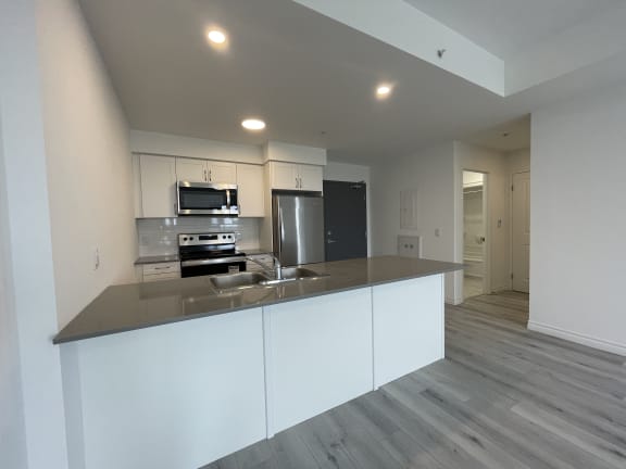 Bayfield Tower Apartments 2 bedroom 2 bathroom variation A open-concept kitchen with breakfast bar and quartz countertops