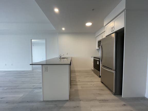 Bayfield Tower Apartments 2 bedroom 2 bathroom variation A kitchen with stainless steel appliances and white cabinets