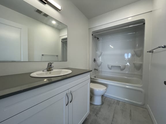 Bayfield Tower 2 bedroom 2 bathroom variation B ensuite bathroom with vanity, mirror, toilet and tub with a shower