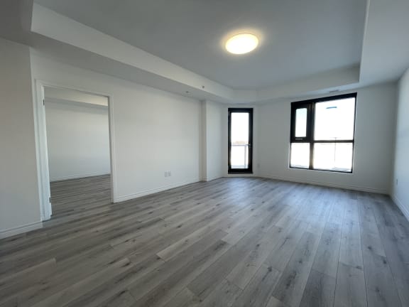 Bayfield Tower 2 bedroom 2 bathroom variation B living room with large window and glass patio door