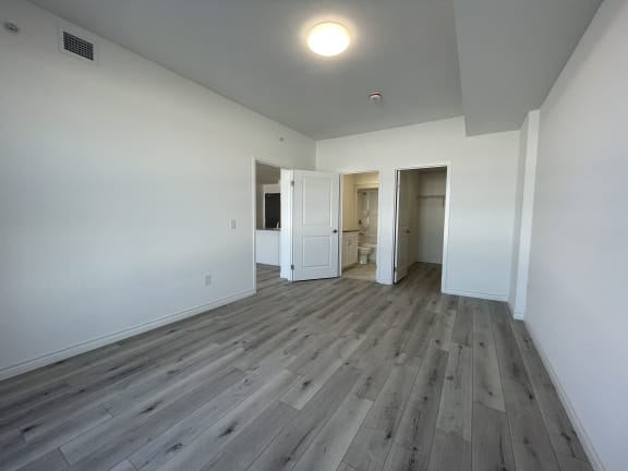 Bayfield Tower 2 bedroom 2 bathroom variation B primary bedroom looking towards ensuite bathroom and walk-in closet