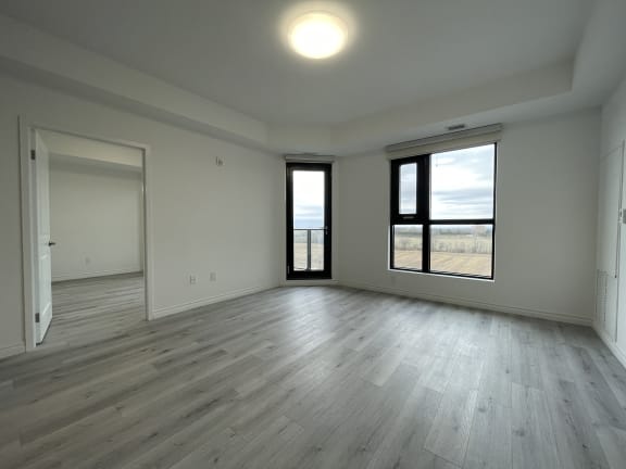 Bayfield Tower Apartments 3 bedroom 2 bathroom variation A living room with large window and glass patio door