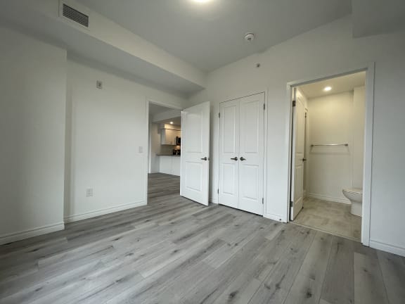 Bayfield Tower Apartments 3 bedroom 2 bathroom variation A primary bedroom looking towards doorway, closet and ensuite bathroom