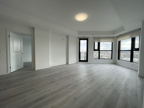 Bayfield Tower Apartments 2 bedroom 2 bathroom variation D living room with large windows and glass patio door