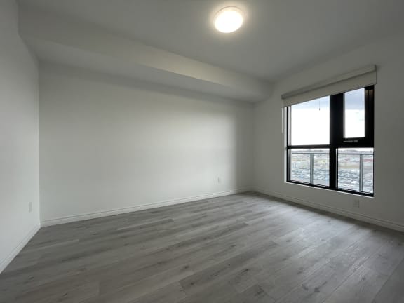 Bayfield Tower Apartments 2 bedroom 2 bathroom variation D primary bedroom with large window as seen from doorway