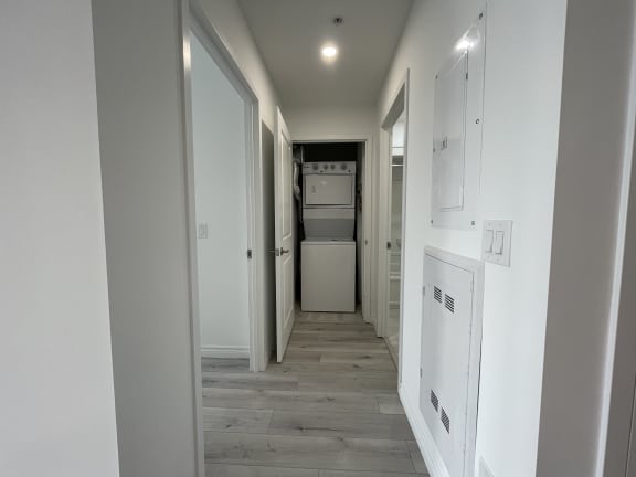 Bayfield Tower 2 bedroom 2 bathroom variation E hallway with stacked washer and dryer at the end of the hall
