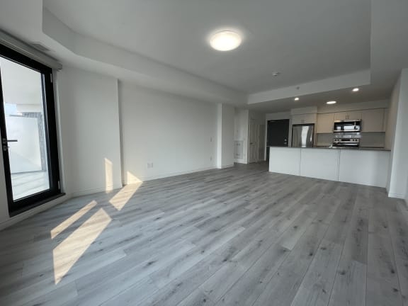 Bayfield Tower 2 bedroom 2 bathroom variation E living room with kitchen in background