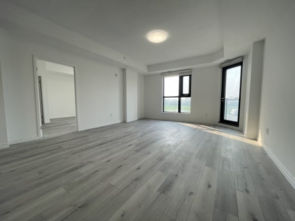 Bayfield Tower 2 bedroom 2 bathroom variation E living room with a large window and glass patio door