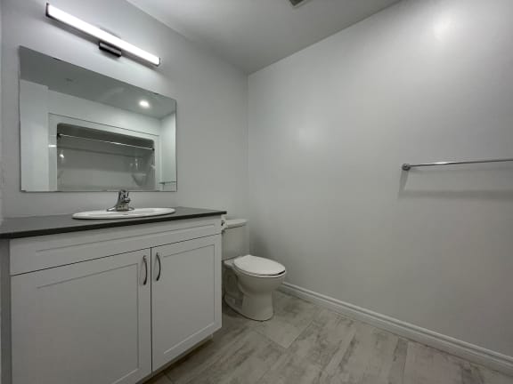 Bayfield Tower Apartments 3 bedroom 2 bathroom variation B large bathroom with vanity, mirror and toilet