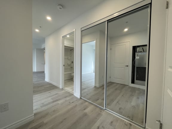 Bayfield Tower Apartments 3 bedroom 2 bathroom variation B hallway closet with double sliding mirror doors