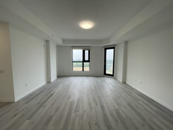 Bayfield Tower Apartments 3 bedroom 2 bathroom variation B living room with large window and glass patio door