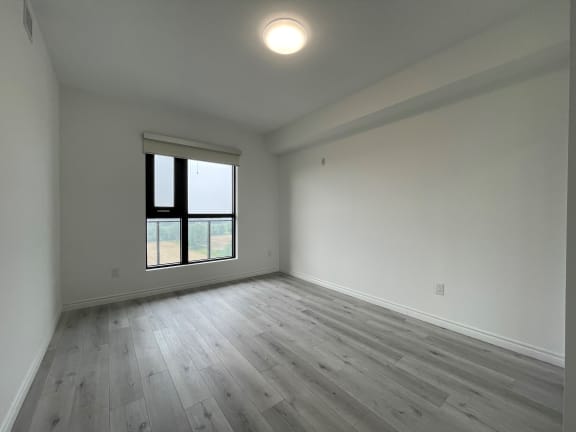 Bayfield Tower Apartments 3 bedroom 2 bathroom variation B primary bedroom with a large window