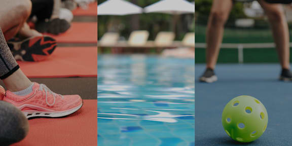 A person is exercising on a red mat by a pool with a green ball on the ground at Amara Apartments,Midvale,UT
