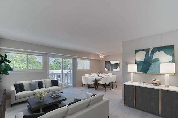 A modern living room with a grey sofa, a coffee table, a dining table set up with chairs, and a large painting on the wall.