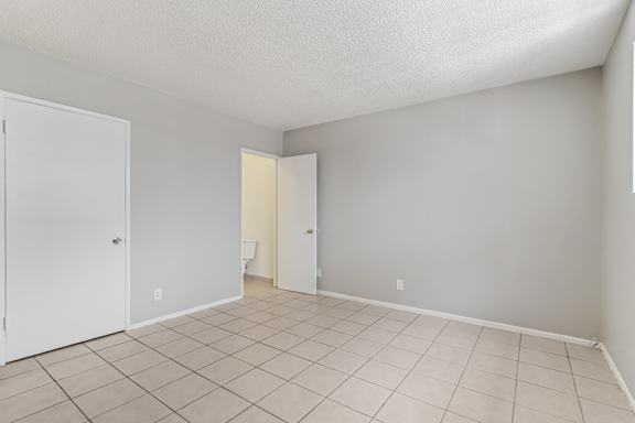A room with a white door and a white wall.