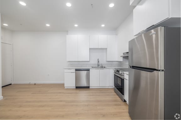 A modern kitchen with a stainless steel refrigerator.