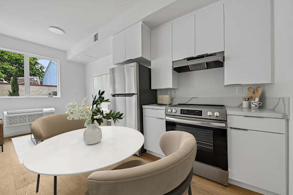 A modern kitchen with a table and chairs.
