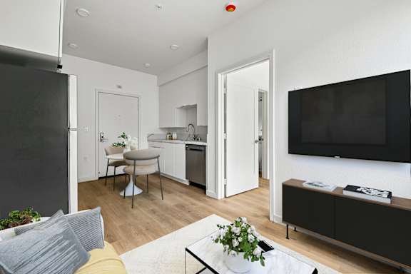 A modern kitchen with a dining table and chairs.