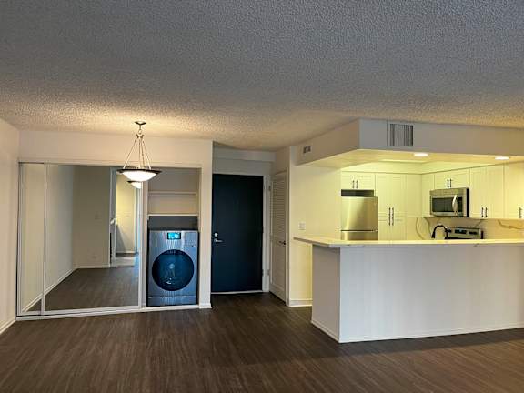 A laundry room with a washer and dryer is shown.
