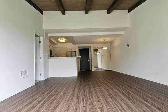 A room with wooden floors and white walls.