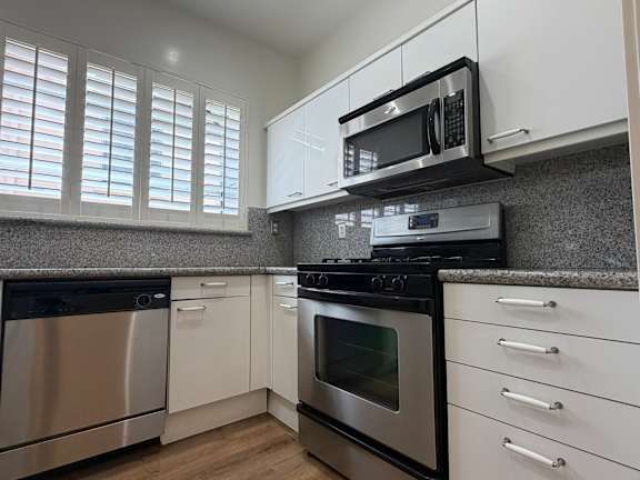 A kitchen with a stainless steel oven and microwave.